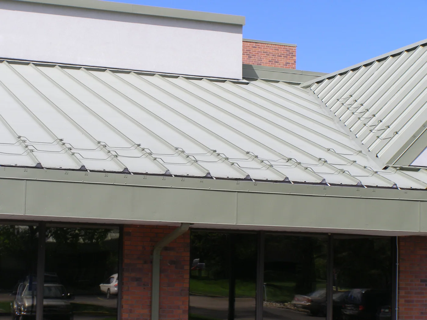 1987 non-penetrating clamp-on bar system for a standing seam metal roof at Chipeta Elementary School