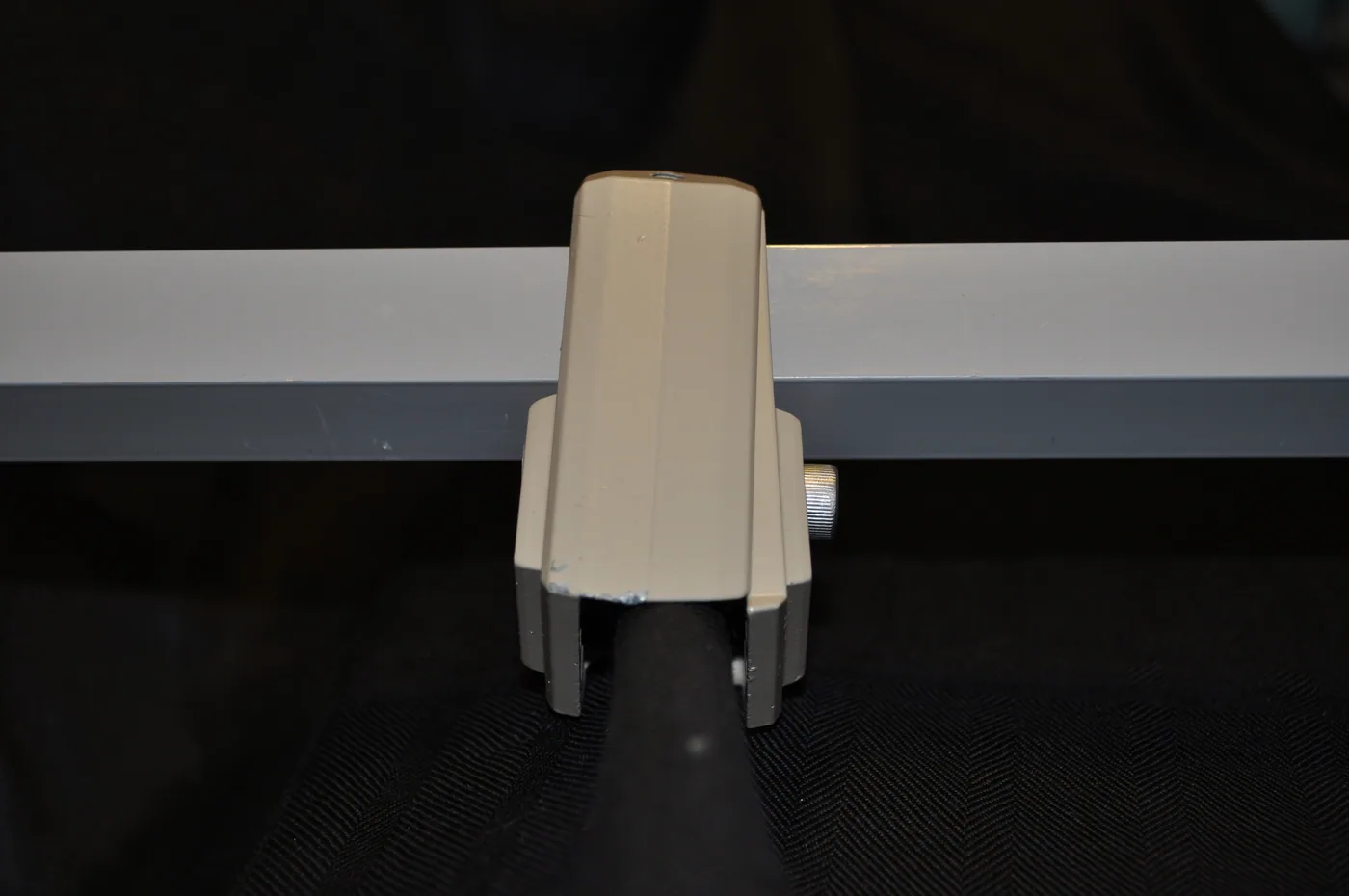 The image above is a 2-piece clamp made of die cast Zinc Zamak that requires the bar to be fed through the clamps and relies on compression in order to stay in