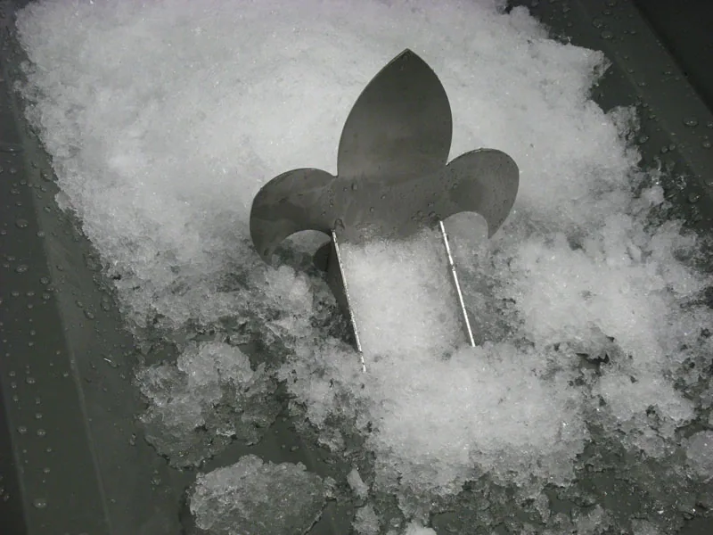 Alternate view of a strap-mounted snow guard on a composite tile roof
