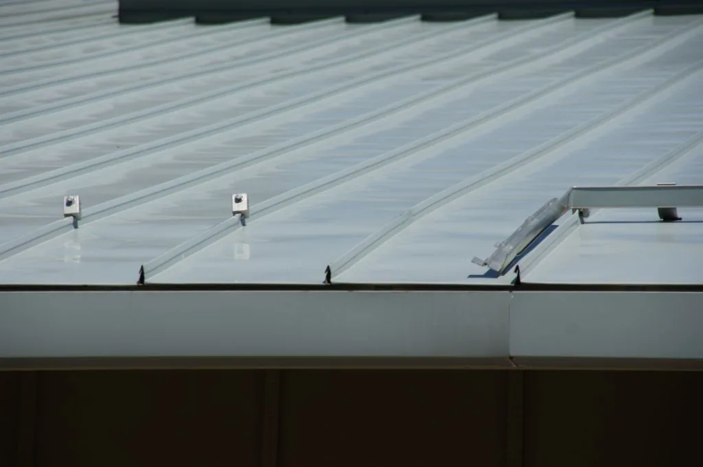 Alternate view of standing seam damage from an overloaded cantilevered clamp system