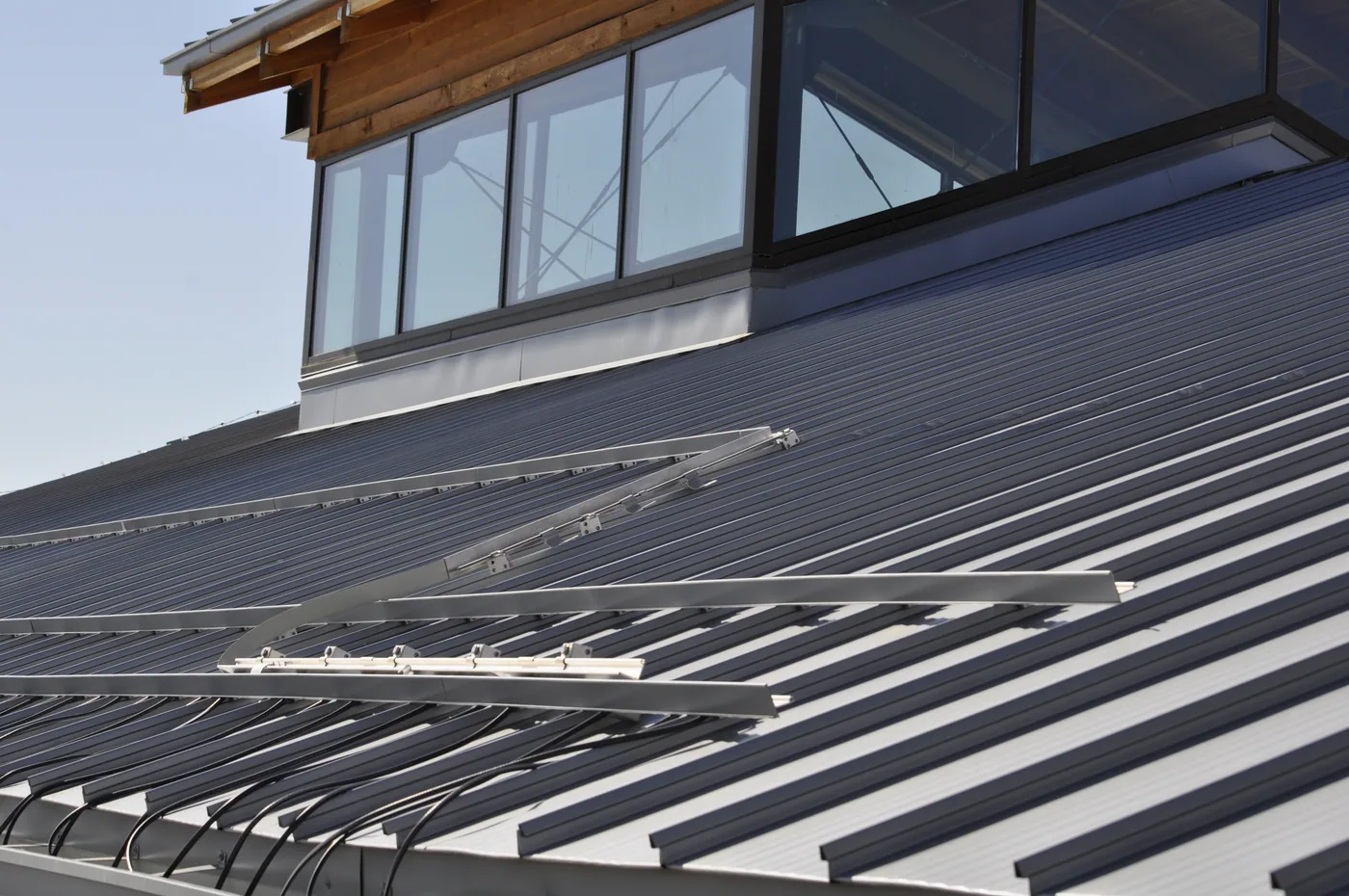 The damage to the seams and bar could have been avoided by equally spacing the rows up the roof and by extending the rows the entire length of the roof