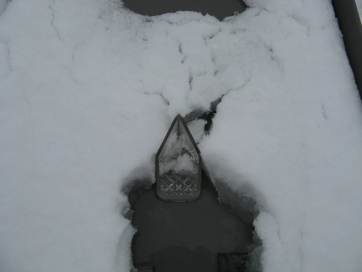 Snow breaker guard used for light snow loads and controlled shedding