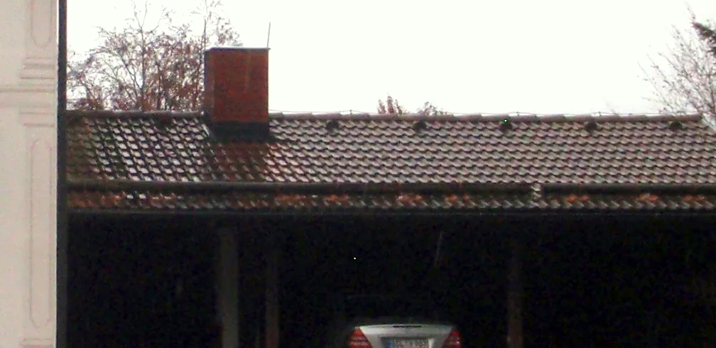 A log “Fence” protects this 3 car garage in Germany