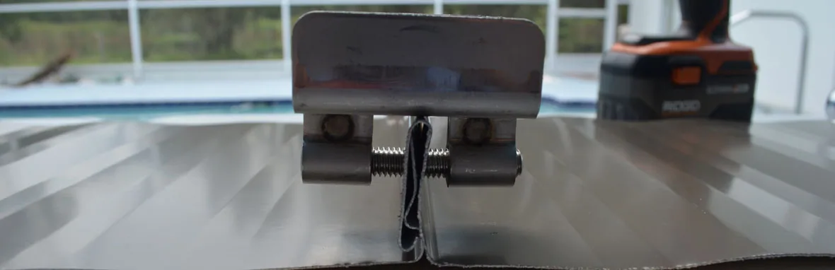 a properly installed stainless steel clamp, utilizing cupped tip set screws, mounted near the end of a seam, to show that there is very little seam distortion at