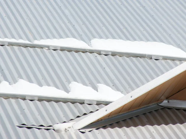 Roof utilizing a specialty corrugated roof bracket for mechanically mounting a bar system to a round corrugated panel