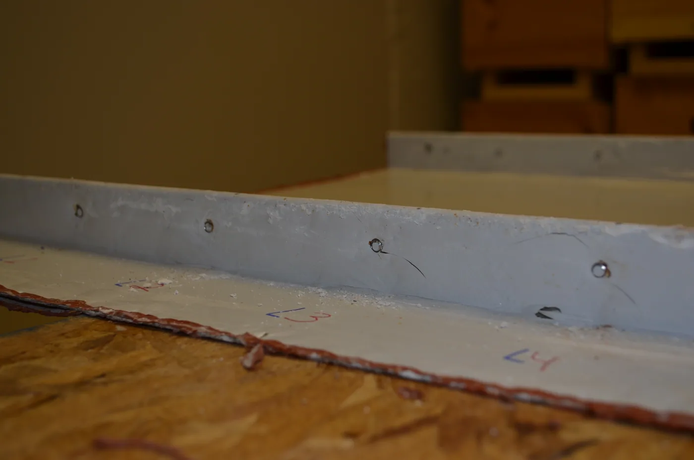 Cupped-tip set screw test showing a self-sealing attachment point on a metal seam