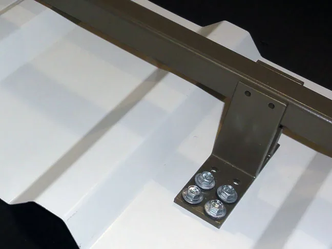 Top loading bracket for exposed fastener roofs, the screws must be fastened into a steel purlin or structural wood